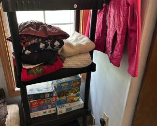 This shelf has some beautiful sweaters on it and further down are some great puzzles!