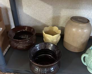 The bottom shelf means nothing about the quality! Here are sone great vintage pieces of stoneware! The tow dark brown pieces I believe are spittoons.