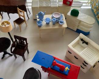 Tow it hen sets, one blue/white, one black/white. Also a kitchen table with china. Green Toaster, red Radio. The red and blue sewing machine is great too!