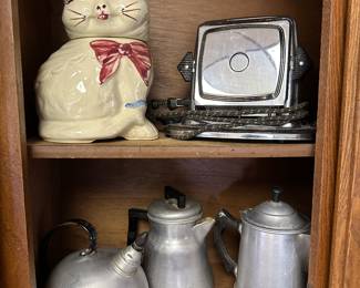 An antique toaster, more coffee, pots, and kettles and a terrific vintage kitty cat cookie jar
