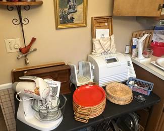 This table in the kitchen holds a stand mixer a beautiful bread maker and accessories under the table are great take pan muffin pans, cookie sheets, etc.