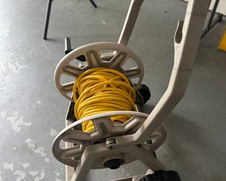 This is interesting - yes its a hose reel, but with a HEAVY long yellow extension cord instead of a hose!