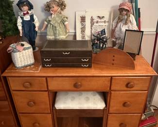 This is a great small wooden student desk with some collectors dolls and jewelry box on top