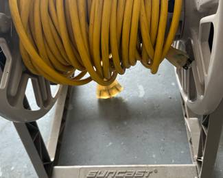 This is interesting - yes its a hose reel, but with a HEAVY long yellow extension cord instead of a hose!