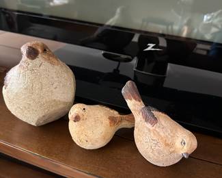 This is a set of three birds made of stone