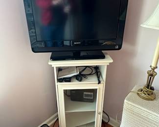 Very nice corner cabinet with glass front and a Sony flatscreen television