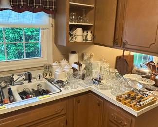 A nice canister, set set of coffee, mugs, and lots of kitchen utensils