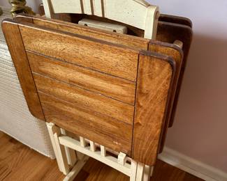 A great set of four heavy TV trays made of wood with wooden rack