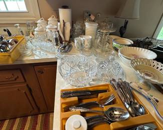 The kitchen counters are filled with very usable, excellent condition, kitchen, utensils, and supplies