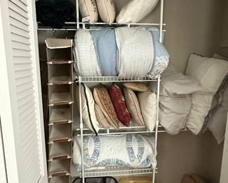 The closet in the living room is filled with linens and pillows also