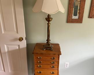 A very nice jewelry chest and on top is a lovely brass lamp