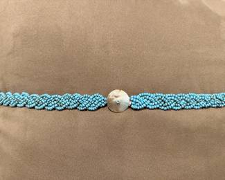 Braided turquoise or glass beaded belt with shell closure.