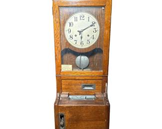 Cincinnati Time Recorder Clock | Cincinnati Ohio, USA, in an oak case, signed face with Arabic numerals. - h. 42.25 x w. 17.25 x d. 12.5 in
