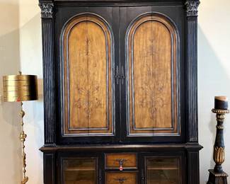 Hooker armoire. 2 front panels open up and tuck inside for access to TV with accent lighting above shelf. Includes 2 small, matching wooden doors that can easily swap out with the glass doors.