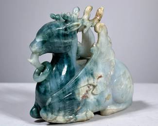 CHINESE CARVED JADE MYTHICAL FIGURE | 
Jade or Serpentine stone, a winged deer carved with rings, no apparent marking. - h. 6 x w. 2 x l. 5 in

