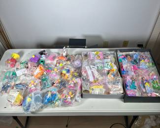 Happy Meal Toy Collection | A large collection of mostly new and unopened McDonald's happy meal toys, including some opened, plus other similar small toys.


