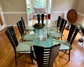 Beveled glass top table atop Frosted Glass Pedestals. 8 "mod" chairs.
