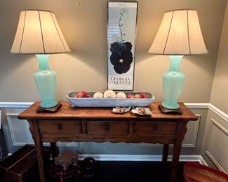 Pair of glass and acrylic beautiful lamps, art and decorative accessories on this console.