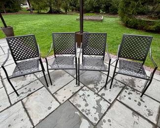 Set of four metal patio chairs. They stack for storage