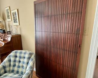 Wood wall panel hangs on wall for decorative purposes