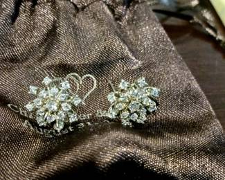 Pair diamond earrings .20 carat center stone with many small diamonds. Tested..