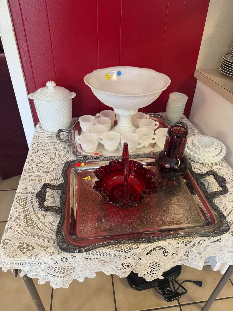 Milk glass punch bowl and silver serving pieces.