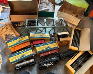 Vintage American Flyer toy train, engine, railroad cars, switches, and tracks with boxes