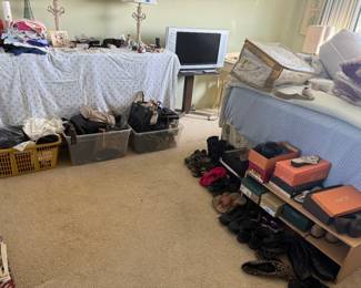 Tons of purses, wallets, men and women’s clothing, shoes, bed linens and comforter sets, blankets, desk, artwork, lamps, etc 