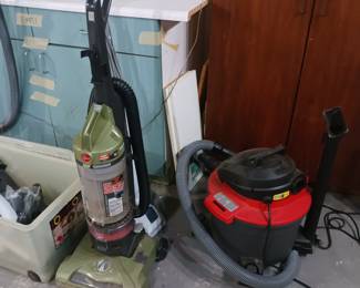 Several vacuum cleaners and shop vacs