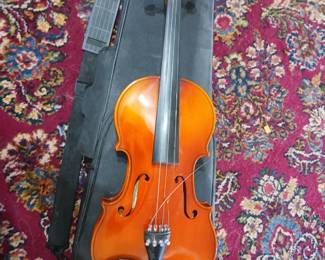 One of two vintage violins this one is made by Suzuki