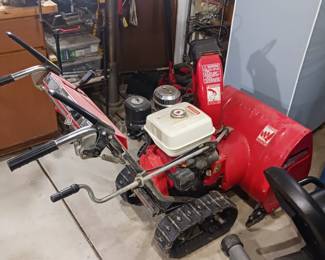 Honda HS80 two-stage snow thrower has an electric start with treads
