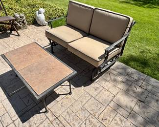 Glider with cushion and tile top table