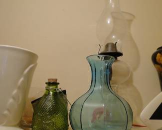 Clear, glass oil lamp, blue vase, and a fun green glass item