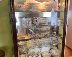 Curio not for sale. Contents include a new in packaging 8 setting Lenox china set, silverware, and glassware.