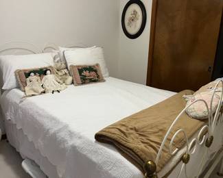 Full size bed.  Cute iron bed frame sold separately from mattress.  2 antique dolls.