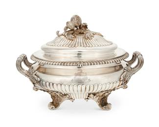 37
1828
A George IV sterling silver tureen
Basin and lid each marked for sterling, London, George IV, and date marked for 1828; maker's mark: IC [in an oval cartouche, possibly Joseph Craddock]; bearing a crest with banner text: Honneur et Fidelite
The sterling tureen, with acanthus leaf-form opposed handles and feet, gadrooned body, and lid with pomegranate finial
Overall: 11.75" H x 15.25" W x 9.5" D
142.6 oz. troy approximately
Estimate: $2,000 - $3,000