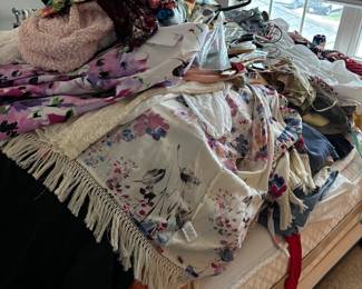 There is a nice double bed under all those clothes