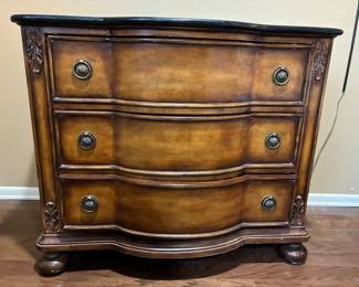 AnotherThree drawer dresser with ornate details.