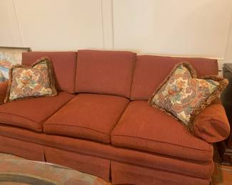Plush reddish-orange sofa with textured fabric. 3 cushion design with 2 accent pillows.
86.5” x 32.5”dx33”t