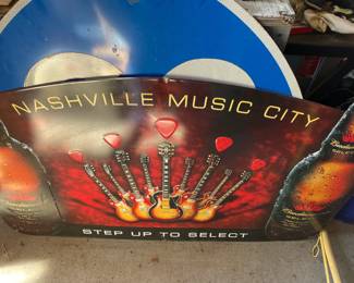 "Nashville Music City Step Up to Select" metal sign with guitars on the face of the sign.