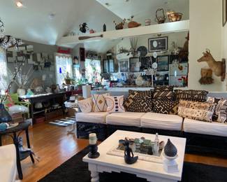 Four piece rattan couch, painted wooden Lane Furniture Co coffee table, Living Room facing the kitchen