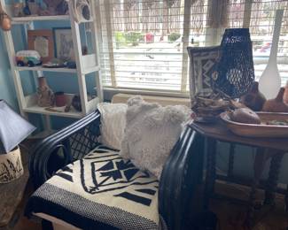 Vintage black painted rattan chair(one of two), vintage Gateleg small table, painted shelf unit loaded with Native American items in Bedroom #1