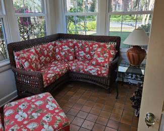 Floral rattan sofa, chair and ottoman.