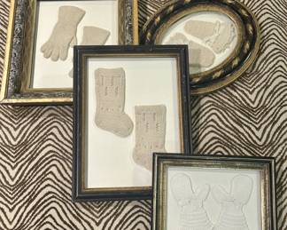 Framed antique knitted and crocheted baby items