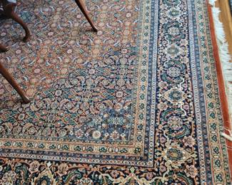 A large 12' x 14' Wool Oriental Rug.