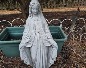 Cement statue and white fencing
