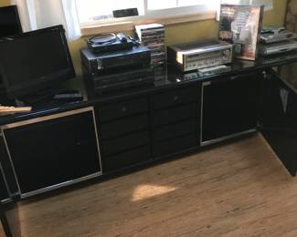 Both front panels slide over and pivot back to reveal 2 sets of drawers and side shelving on glass!