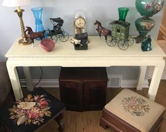 Matching Baker Furniture console table! Underneath are a couple of crewel work ottomans and a storage cabinet for coins!