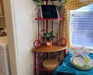 Fun  bright red wrought iron corner shelf. Also food scales and plants