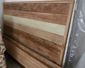 King Farmhouse headboard, footboard, side rails.  Queen sized mattress leaning behind bed set